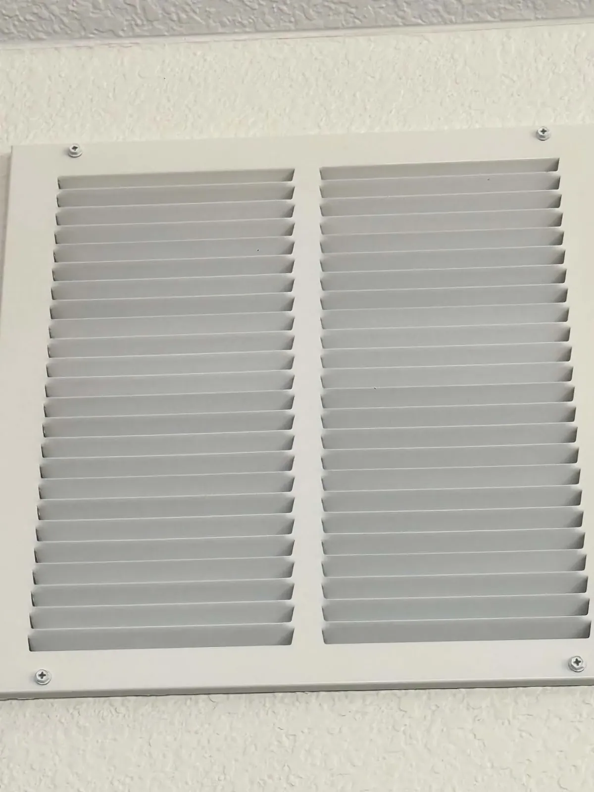 Clean dryer vent cover on an interior ceiling