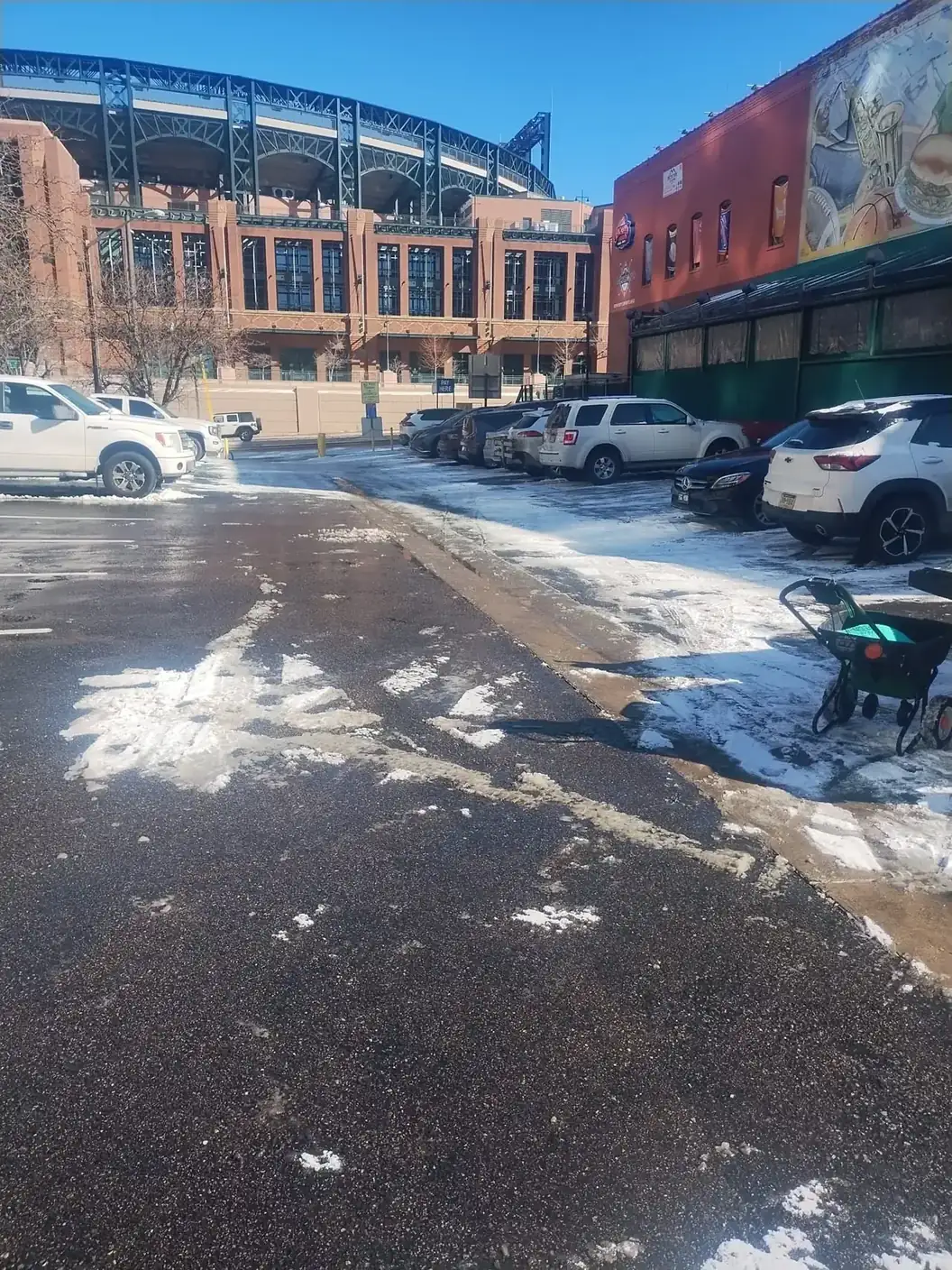 Cleared parking lot near a downtown stadium after a snowstorm