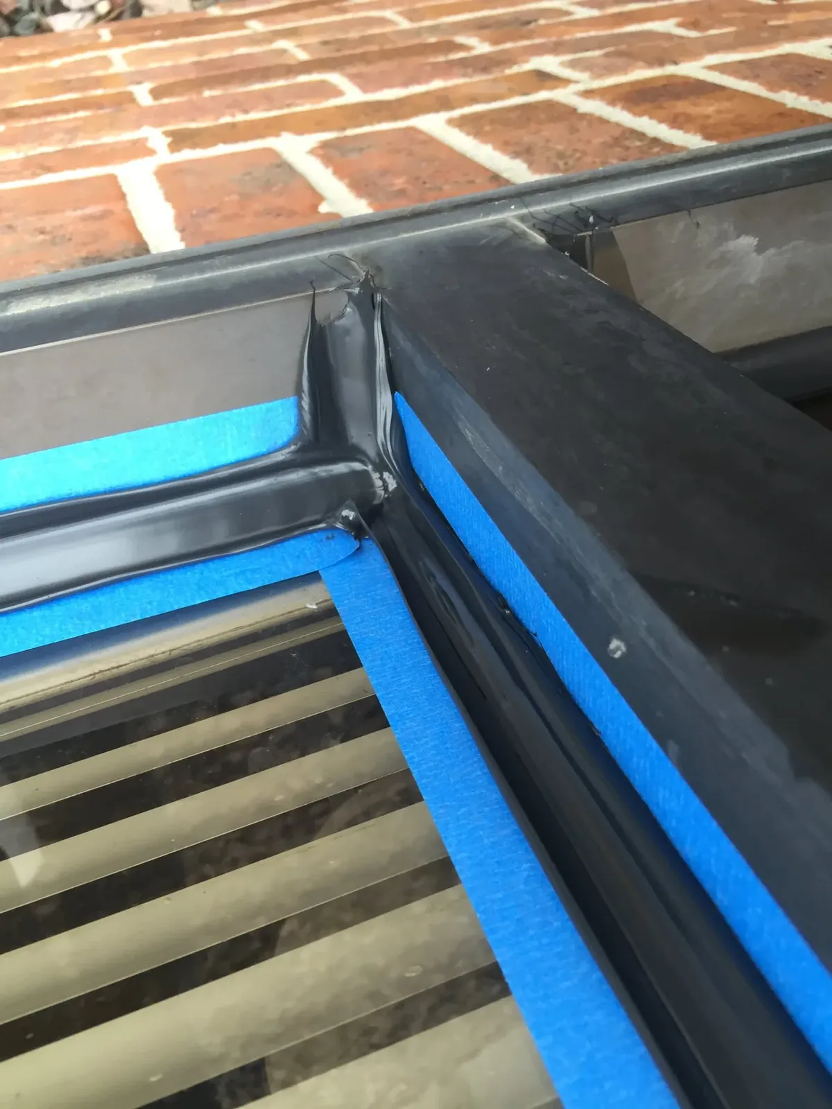 Close-up of a finished caulk seal at a window corner