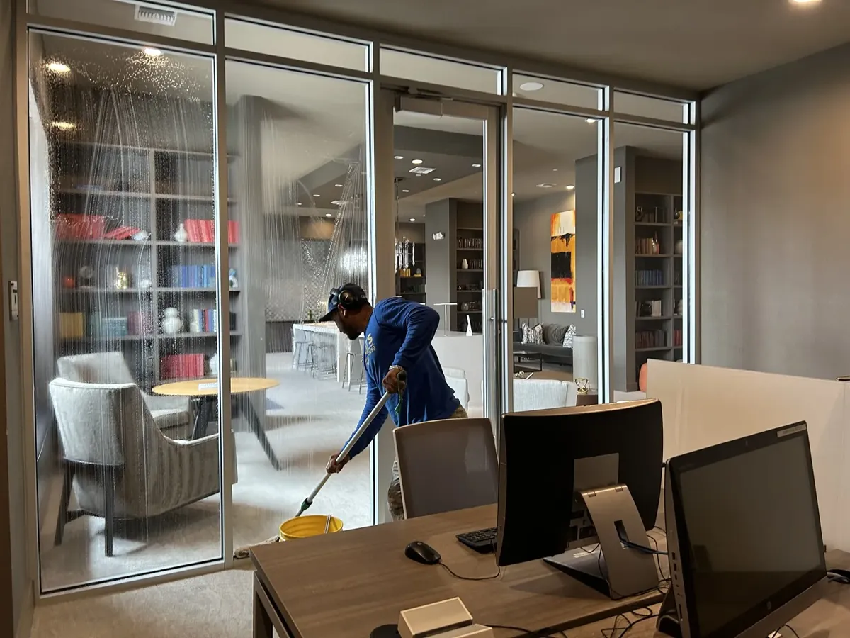 Sample: Joe's technician cleaning the glass walls of a modern office