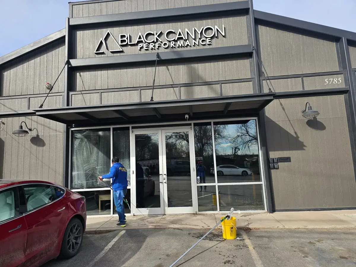 Joe's technician cleaning the storefront glass of a commercial building