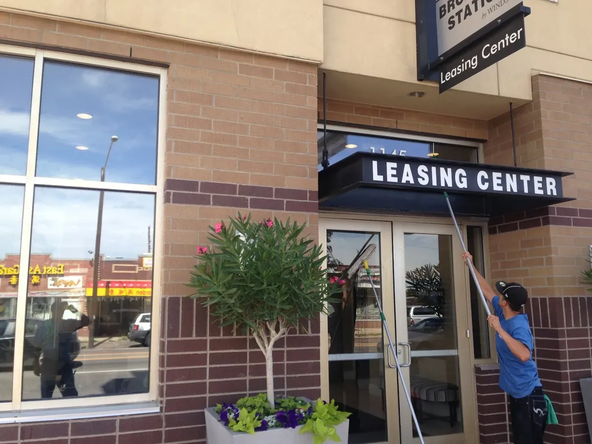 Sample: Joe's technician cleaning the entrance glass and canopy of an apartment leasing center