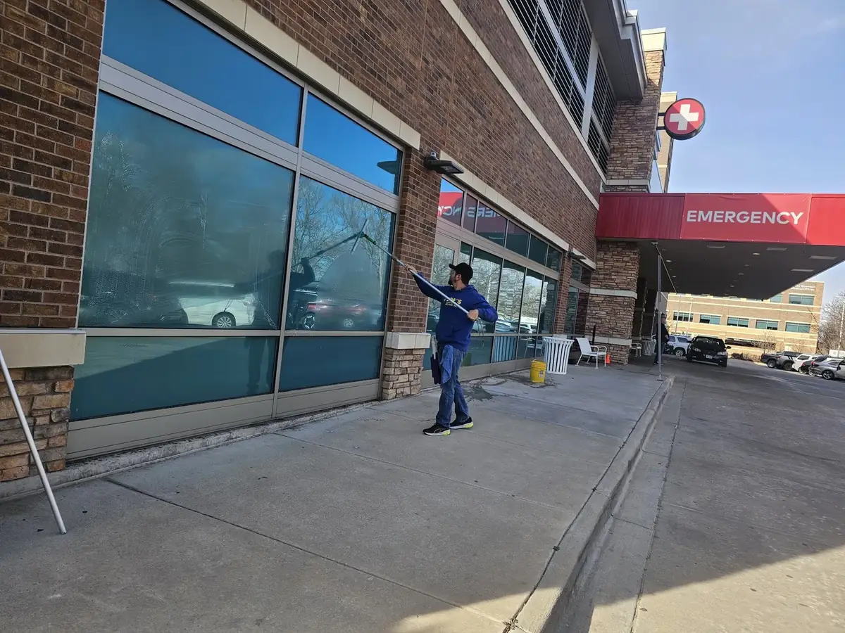 Joe's technician squeegeeing large windows at a medical building entrance