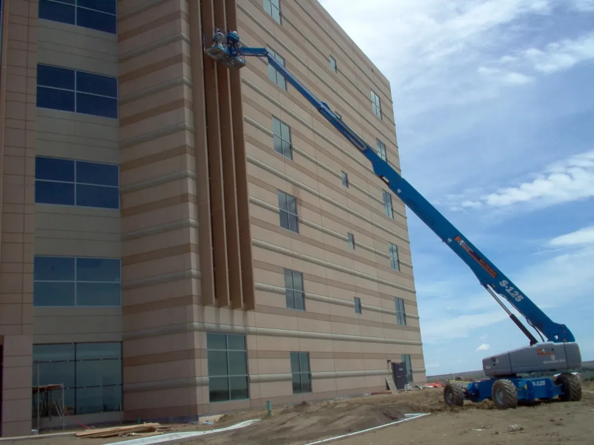 Joe's crew on a boom lift cleaning the windows of a multi-story building