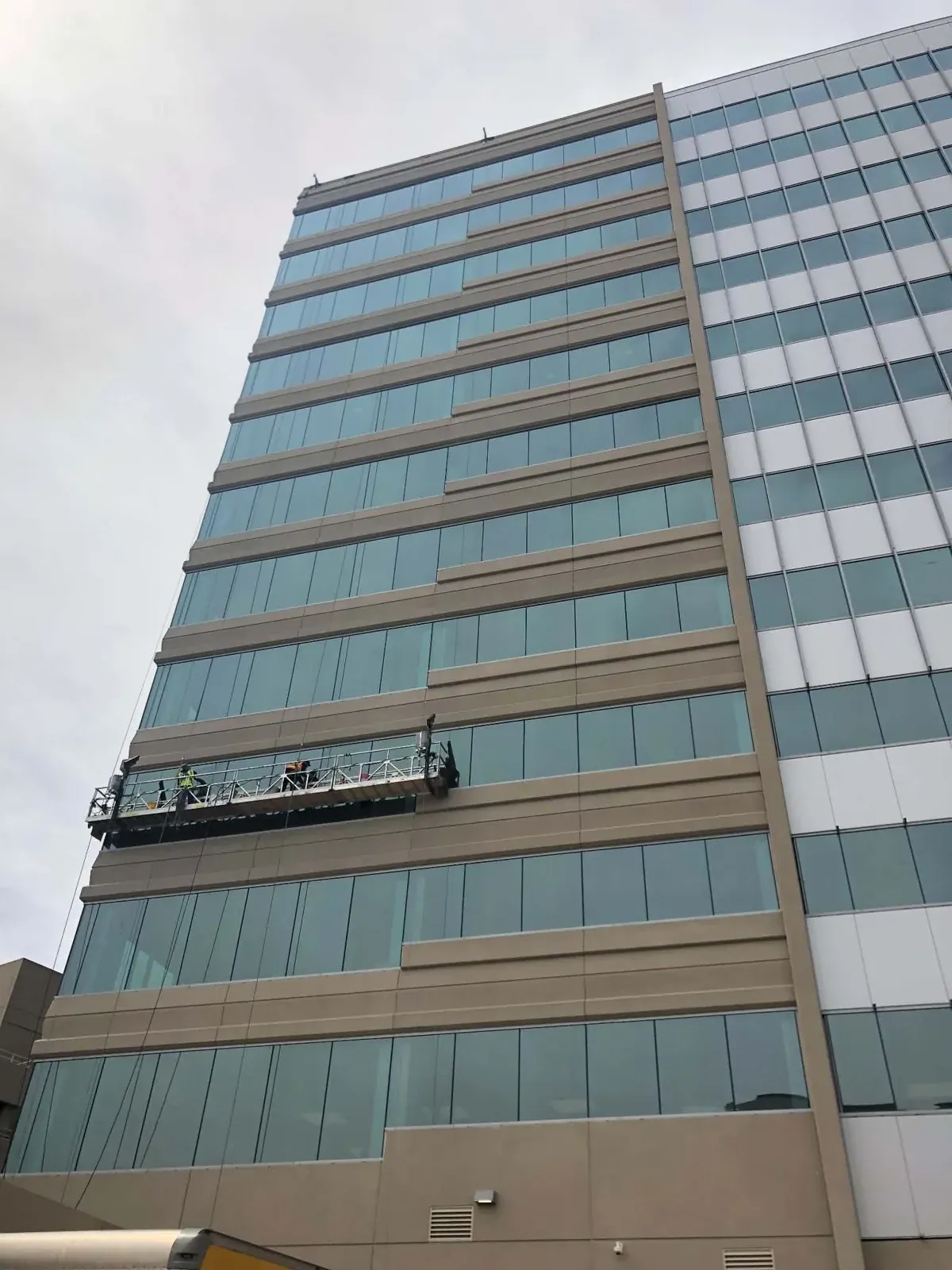 Swing-stage platform cleaning the windows of a 10-story office building