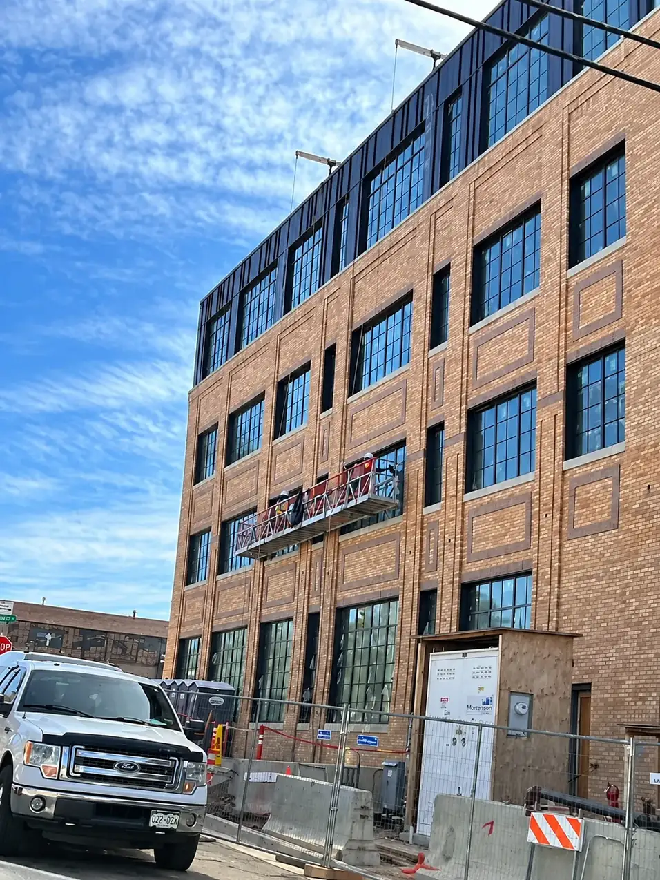Swing stage platform cleaning the windows of a brick building