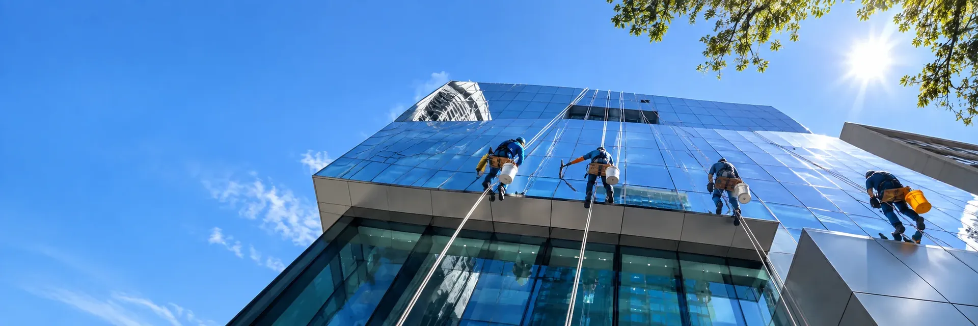 Joe's Window Cleaning technicians on rope access cleaning the glass facade of a high-rise building