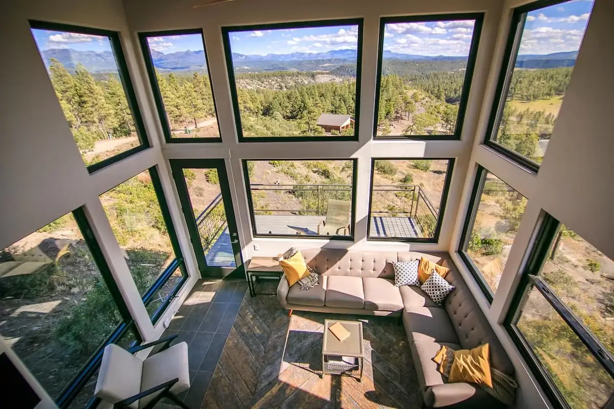 Bright living room with floor-to-ceiling windows overlooking the mountains
