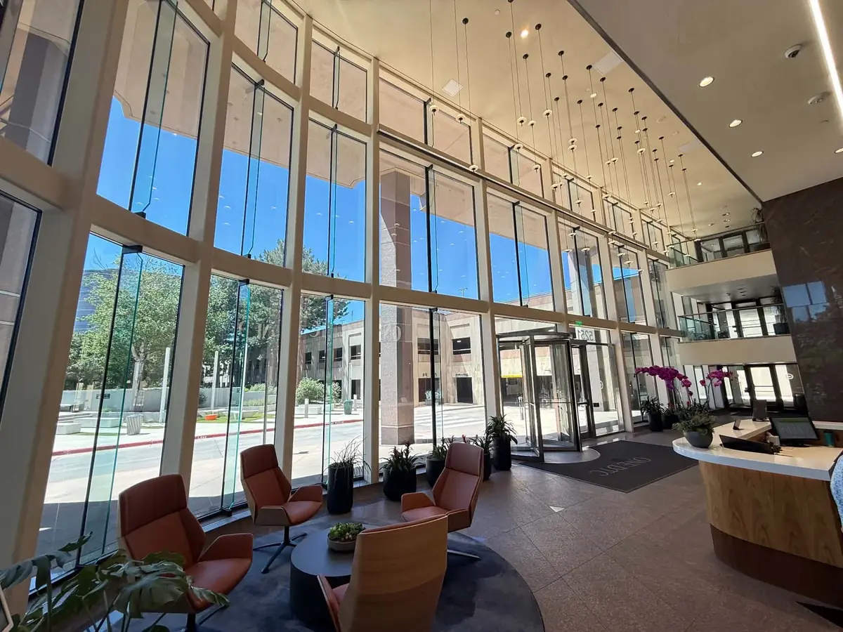 Sample of freshly cleaned floor-to-ceiling glass in a commercial building lobby
